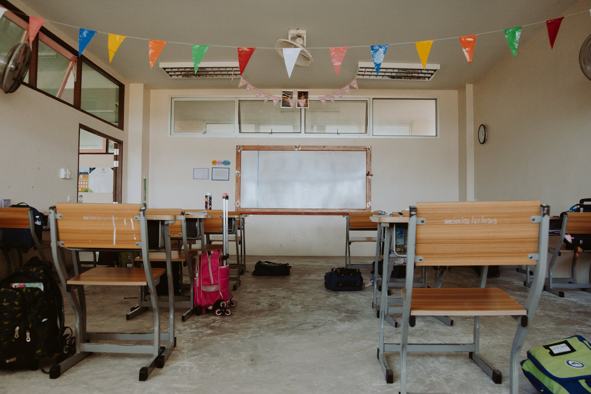 rows of chairs and desks in empty classroom